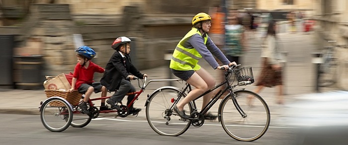 Family riding with a bicyle trailer