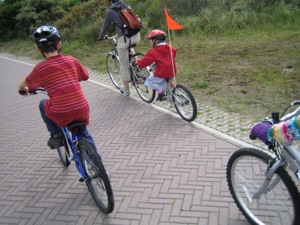 Family cycling on paved path