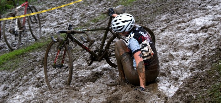 A cyclocross rider stuck in the mud