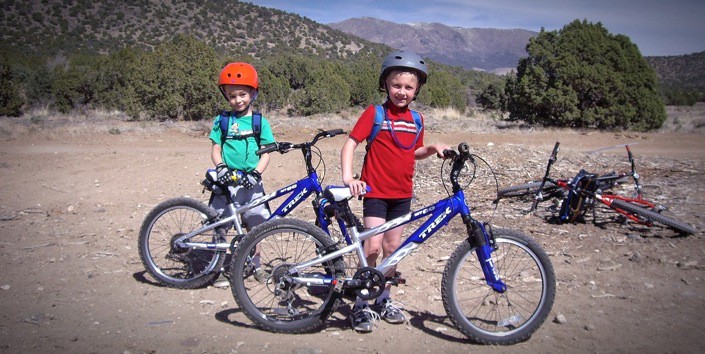 two boys riding mountain bikes