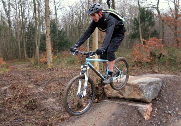 clearing a drop-off on a mountain bike