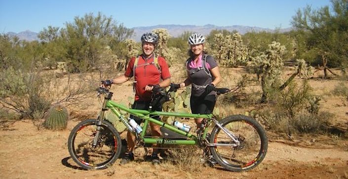 A tandem bike riding couple