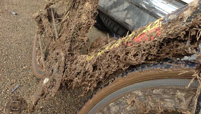 Cyclocross bike covered with grass and mud