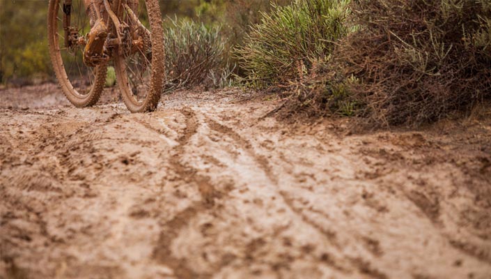 muddy mountain bike mtb heading up muddy trail