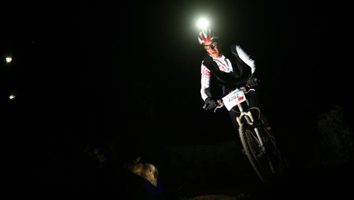 Mountain biker with bicycle lights to see and be seen at night