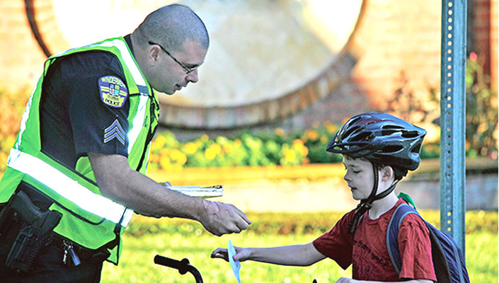 Police officer issues child bicyclist a citation