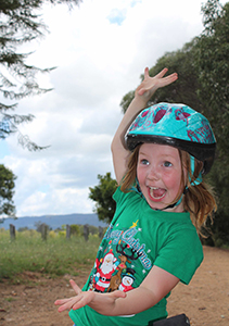 excited kid wearing bike helmet