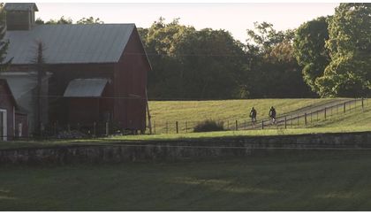 Passing a barn while gravel bicycle riding