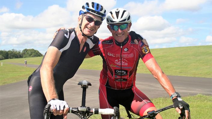 Two masters cyclists smiling on a ride