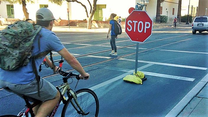Cyclist riding up to a stop sign