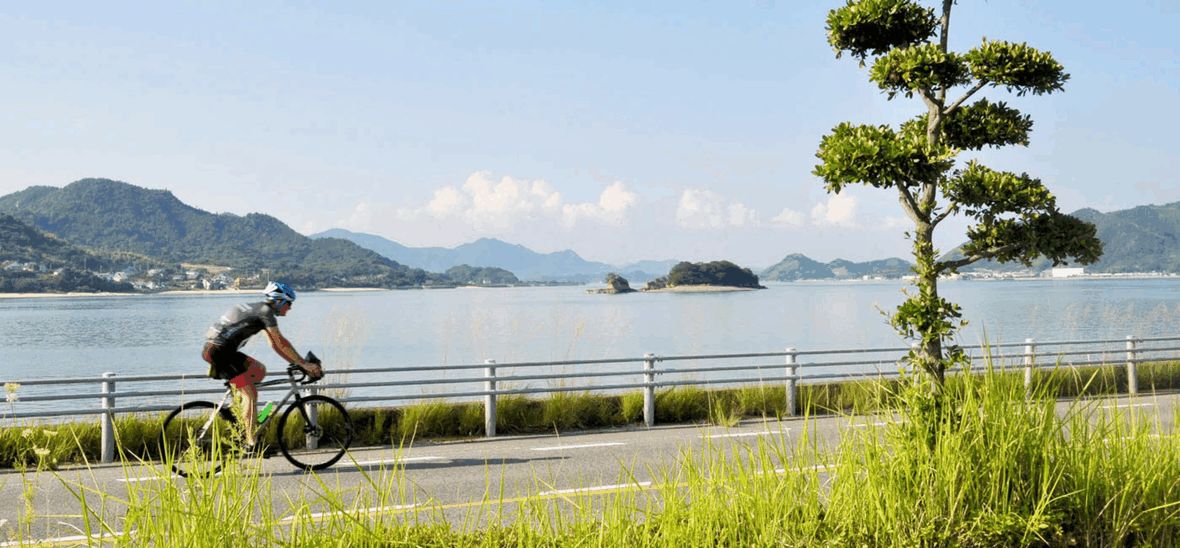 Cycling Coastal Japan Cyclist riding along coastal road
